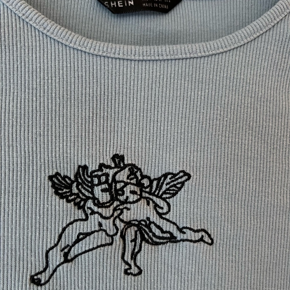 SHEIN Sky Blue Ribbed Top with Black Angel Design